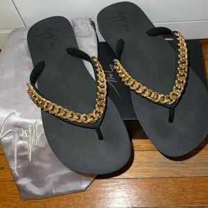 Giuseppe Zanotti black flip flops with gold chain detail